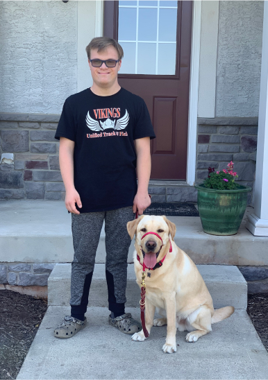 Man standing besides his service dog
